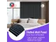 Parrot Black Wood acoustic slatted wall panel installed as a feature wall behind a bed