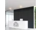 Parrot Black Wood acoustic slatted wall panel installed behind a modern reception counter